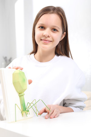 Child's health. The teenager is watching the virus model.の写真素材