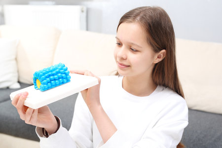 Virus. The teenager is watching the virus model.の写真素材