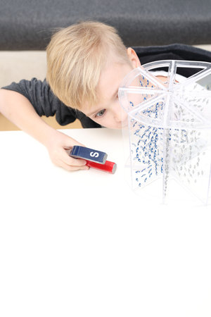 Child at school. The student conducts the experiment using teaching aids.の写真素材