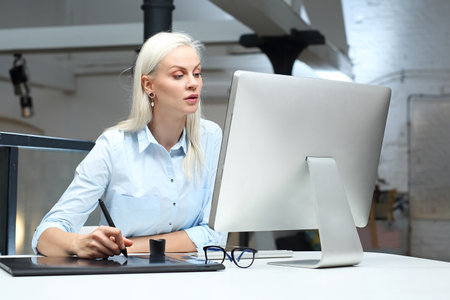 A young woman is working at the computer.の写真素材
