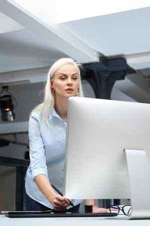 graphic designer. A young woman is working at the computer.の写真素材
