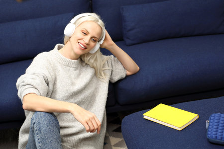 Relaxation. A woman relaxing while listening to music on headphones.の写真素材