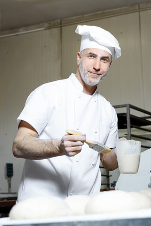 Baker. The process of baking breadの写真素材