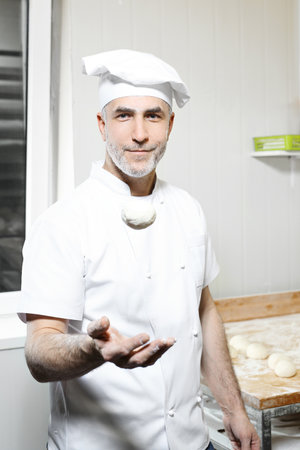 Pizza dough. The man kneads the dough.の写真素材