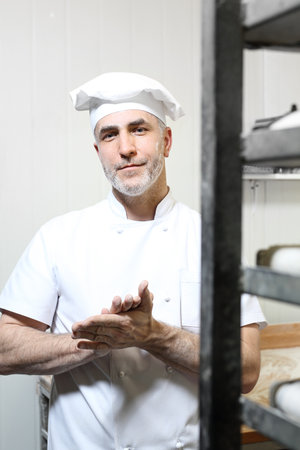 Kneading the dough. Baker, pastry chef prepares the dough for baked goodsの写真素材