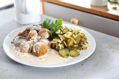 Meatballs. Meatballs in a cream sauce with buckwheat and a cucumber salad.の写真素材
