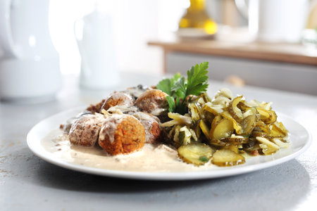Homemade meatballs. Meatballs in a cream sauce with buckwheat and a cucumber salad.の写真素材