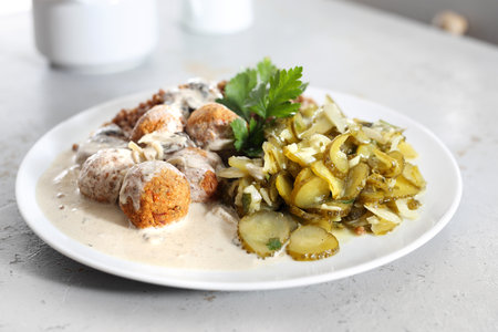 Meatballs in a cream sauce with buckwheat and a cucumber salad.の写真素材