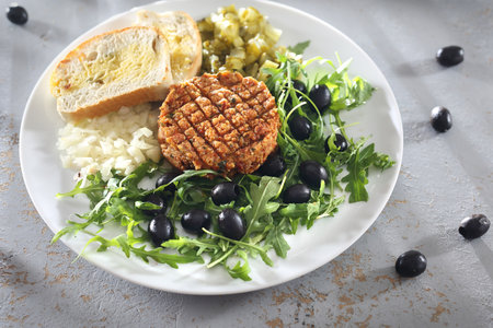 Vegetable tartare with lettuce. Vegetable snack served with olives and cucumber.の写真素材