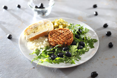 Vegetable tartare with lettuce. Vegetable snack served with olives and cucumber.の写真素材