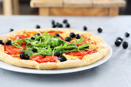 Pizza. Pizza with tomatoes, black olives, arugula.の写真素材