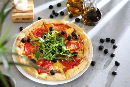 Margherita. Pizza with tomatoes, black olives, arugula.の写真素材