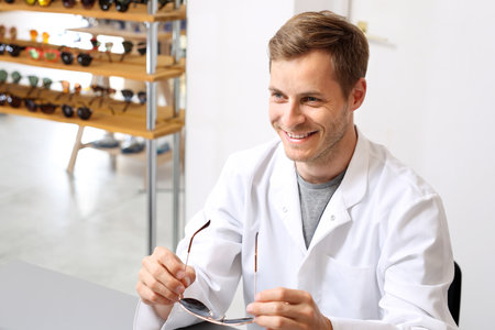 Oculist. A handsome ophthalmologist in an optical salon.の写真素材