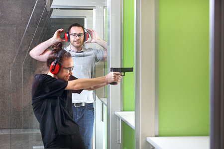 Shooting range. The woman shooting from the gun.の写真素材
