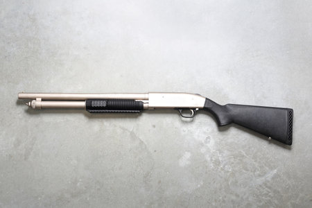 Gun. Windbreaker, rifle on a gray background.の写真素材