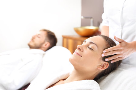 Facial massage for two. A woman in a spa salon.の写真素材
