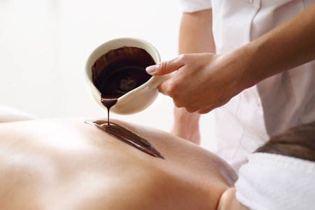 Massage with chocolate. Relax for the body in the spa salon.の写真素材