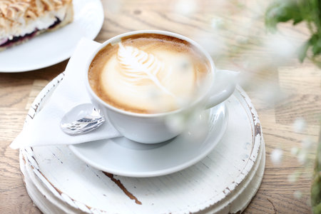 Cappuccino. A cup of hot coffee with a beautiful finish on the foam.の写真素材