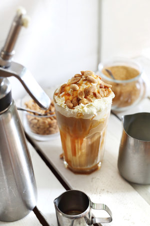 Coffee with salty caramel and nuts.の写真素材