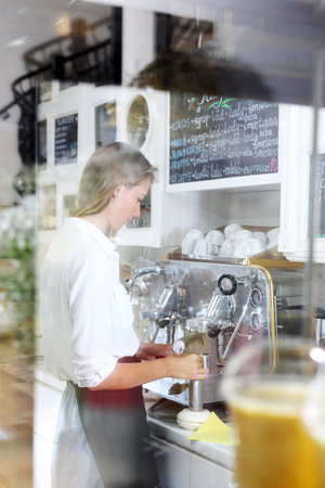 Work in a cafe. Waitress prepares coffee in a cafe.の写真素材