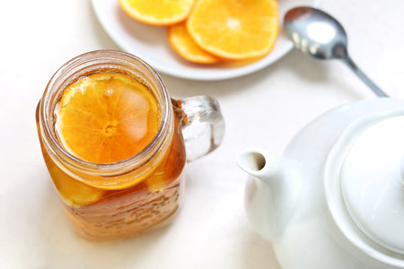 Orange tea. A glass with pieces of orange and cloves.の写真素材