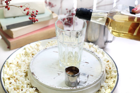 Amaretto coffee. A glass of coffee with milk and cream with the addition of popcorn.の写真素材