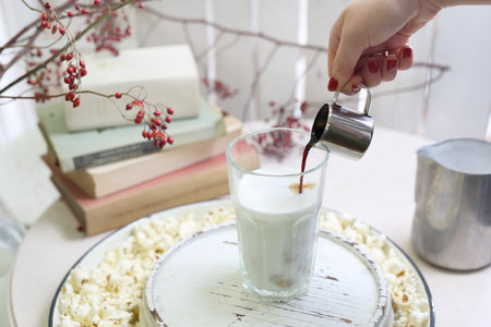 Cafe latte. A glass of coffee with milk and cream with the addition of popcorn.の写真素材