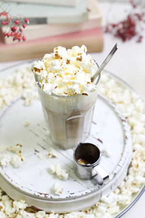 Coffee dessert. A glass of coffee with milk and cream with the addition of popcorn.の写真素材
