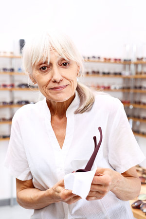 Optician. An elderly woman in an optical salonの写真素材