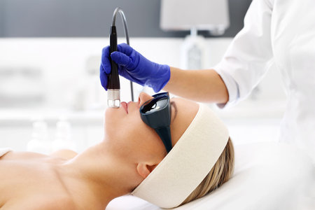 Laser treatment for the face. A woman in a beauty salon during a laser treatment.の写真素材