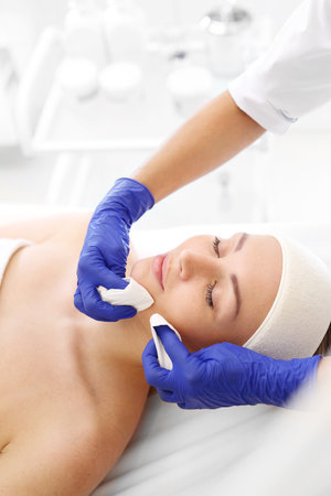 Manual facial cleansing. Cleansing facial skin, blackheads squeezed beautician.の写真素材
