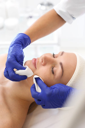 Manual facial cleansing. Cleansing facial skin, blackheads squeezed beautician.の写真素材