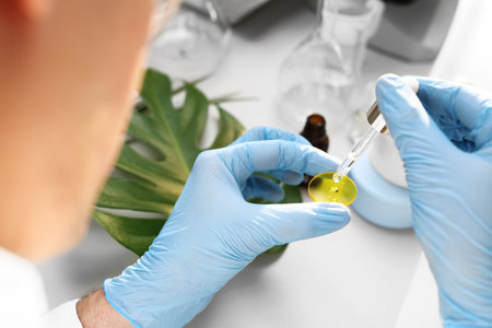 Floral oil. Production of cosmetics. Scientific laboratory. The engineer is studying plants.の写真素材