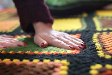 Crocheting. Colorful woolen pillow and bedspread crocheted.の写真素材