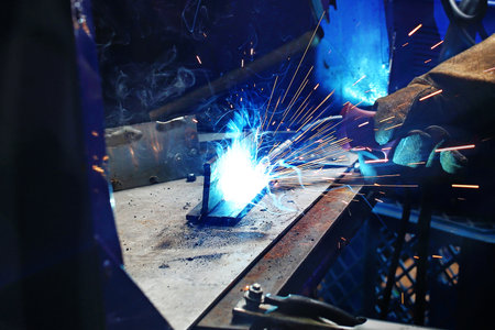 Welder. The man is welding in the workshop.の写真素材