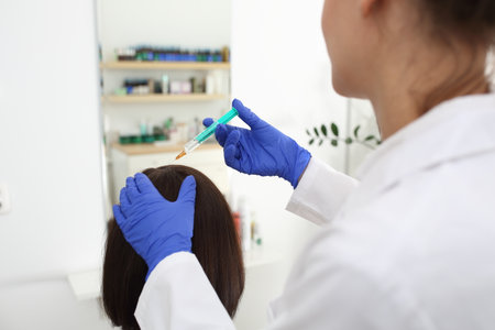 Head mesotherapy, skin injection. A woman in a doctor's office at the surgery.の写真素材