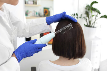 A hair treatment. A woman in a trichological office.の写真素材