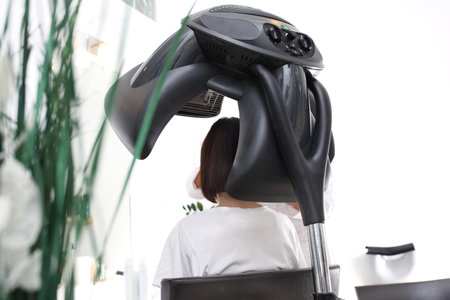 Hair care. A woman during a hair care treatment at the hair salon.の写真素材