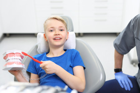 A dental office, a child in a dental chairの写真素材