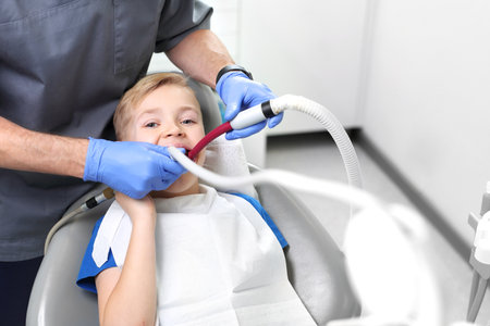 Child at the dentist. Tooth treatment, the dentist cleans the cavityの写真素材