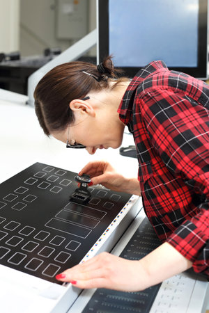 The printer checks the printout. Offset printing. Operation of the printing machine. The printer...