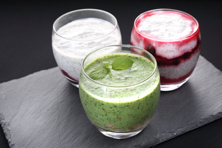 Composition of dietetic desserts, milk with chia seeds, yoghurt with fruit mousse and green fruit and vegetableの写真素材