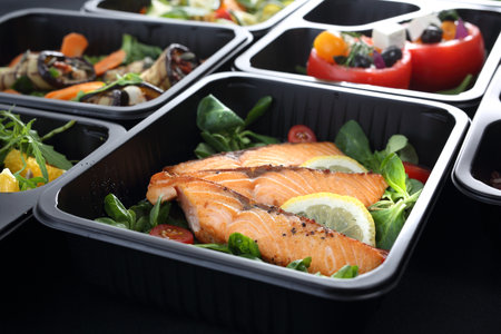 Healthy food and diet concept, restaurant dish delivery. Take away of fitness meal. Weight loss nutrition in foil boxes.の写真素材