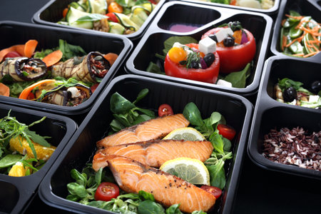 Healthy food and diet concept, restaurant dish delivery. Take away of fitness meal. Weight loss nutrition in foil boxes.の写真素材
