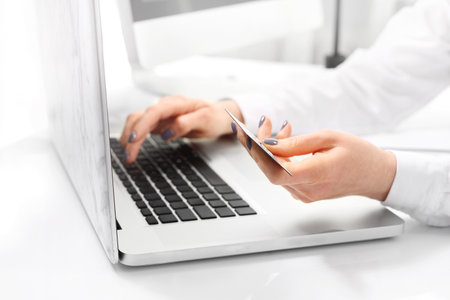 Online shopping with a credit card. The woman pays online for shopping.の写真素材