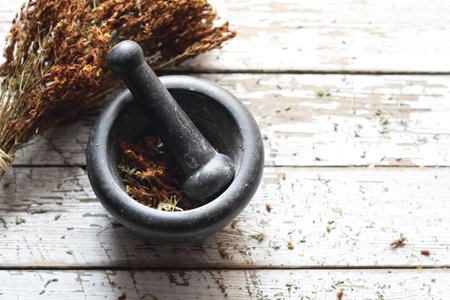 Herbology and herbal medicine, preparing a herbal mixture in a mortarの写真素材