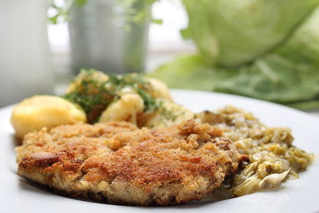 Traditional  Polish cuisine, pork chop with potatoes and fried cabbage.の写真素材