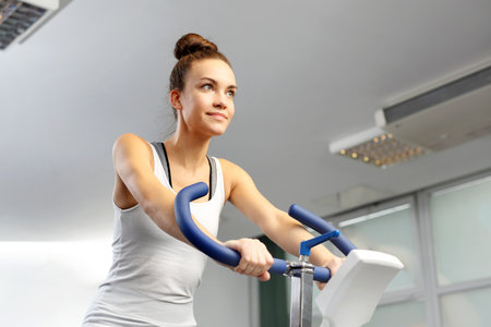 Spinning, training on a stationary bicycle. Fitness club.の写真素材