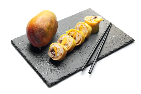 Fruit sushi, a sushi roll with mango and chocolate sauce.の写真素材