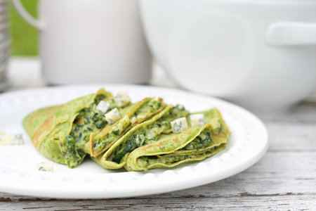 Green pancakes with spinach and blue cheeseの写真素材